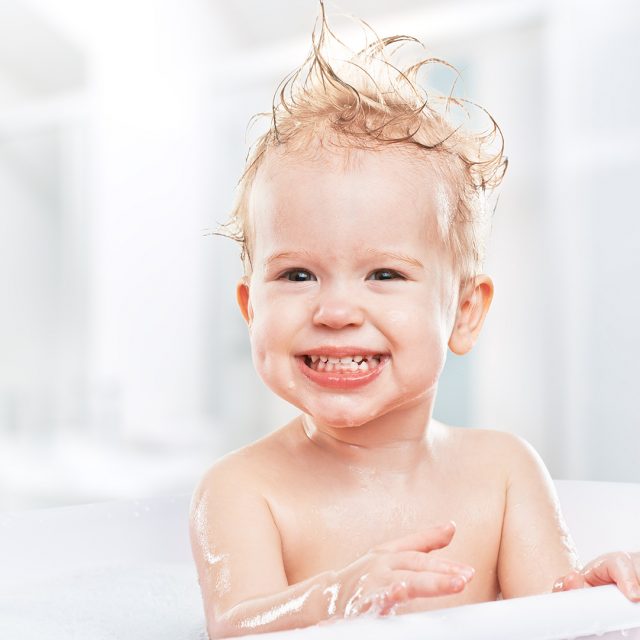 happy funny  baby  laughing and bathed in bath