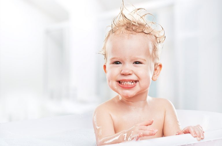happy funny  baby  laughing and bathed in bath